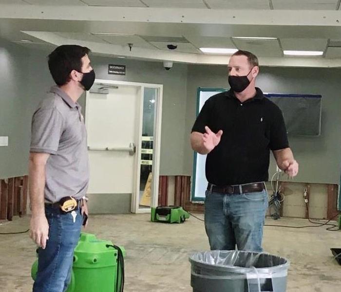 Two men talking in a commercial building